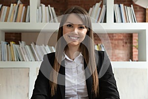 Smiling young businesswoman teacher looking at camera at job interview