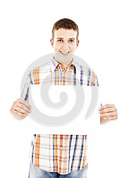 Smiling young casual man holding white sign