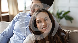 Smiling young caucasian couple enjoying sweet tender moment indoors.