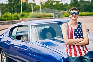 Smiling young Caucasian man standing at his car