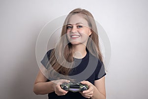 Smiling young caucasian woman girl holding joystick game pad controller, playing computer game.