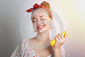 Smiling young Caucasian woman girl is putting sunscreen lotion cream on. Summer uv protection concept