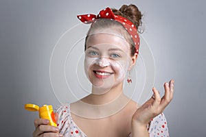 Smiling young Caucasian woman girl is putting white sunscreen lotion cream with funny face. Summer uv protection concept