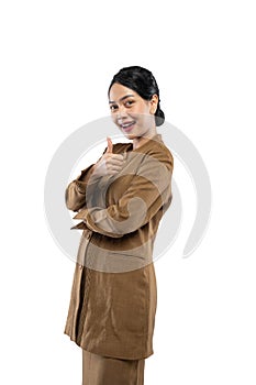 Smiling young civil servant woman standing with thumbs up