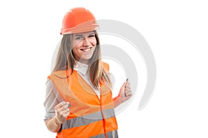 Smiling young construction woman enjoying her success