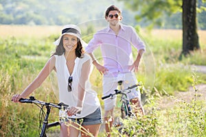 Smiling young couple with bicycles
