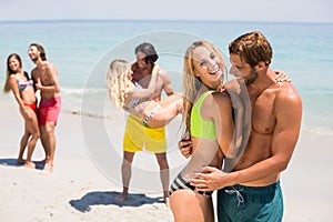 Smiling young couple embracing at beach