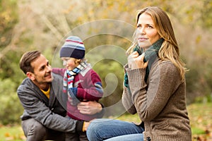 Smiling young couple with little boy posing