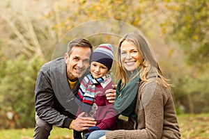 Smiling young couple with little boy posing