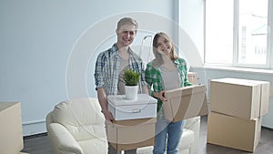 Smiling Young couple moves to a new apartment