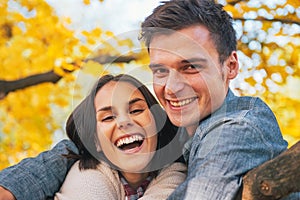 Smiling young couple outdoors in autumn