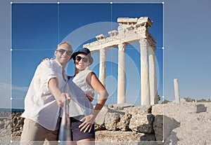 Smiling young couple take a selfie photo on antique ruins