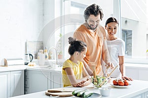 smiling young family cooking together and having fun