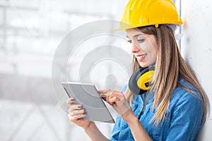 Smiling young female construction worker