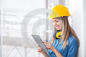 Smiling young female construction worker