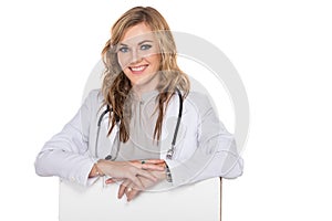 Smiling young female doctor with stethoscope and white blank boa