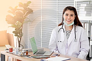 Smiling young female physician wear white coat with stethoscope