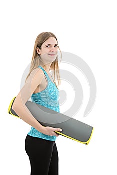 Smiling young fitness girl with an exercise mat