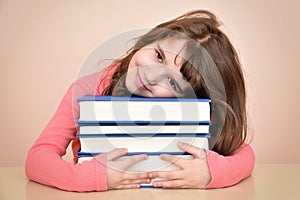 Smiling young girl and books