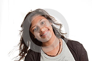 Smiling young girl with braces, tilted head