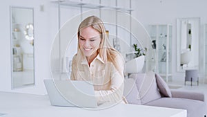 Smiling young girl communicating by video live using computer, microphone and webcam