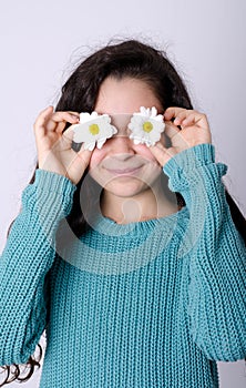 Smiling Young Girl Covering her eyes with Flowers