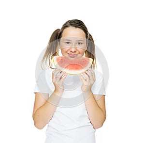 Smiling young girl eating a slice of watermelon