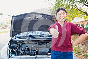 Smiling young girl with good car check up thumbs up