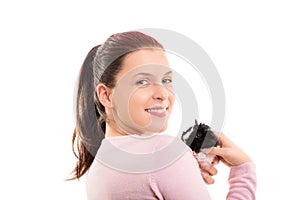 Smiling young girl holding her guinea pig