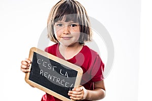 Smiling young girl holding writing slate for cool back to school