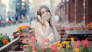 Smiling young girl listen to music on headphones