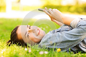 Smiling young girl lying on grass