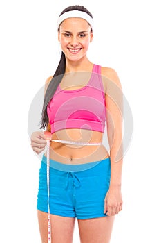 Smiling young girl measuring her waist