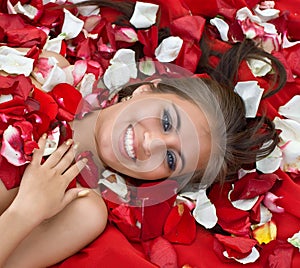 Smiling young girl in rose petal