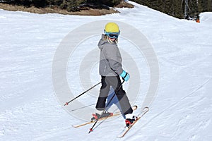 Smiling young girl with ski