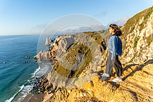 Smiling Young Girl Stands on Edge of Cabo da Roca