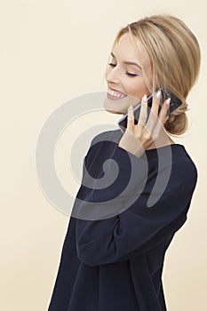 Smiling young girl talking on the phone