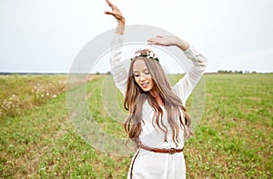 Smiling young hippie woman on cereal field