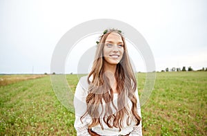 Smiling young hippie woman on cereal field