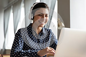 Smiling young indian student attending educational lecture online.