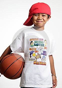 Smiling young lad holding his basketball photo