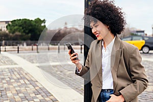 smiling young latin woman using a smart phone