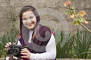 Smiling Young Little Girl Is Strapped an Analogue Camera on Her