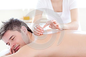 Smiling young man in an acupuncture therapy