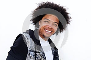 Smiling young man with afro standing against white background