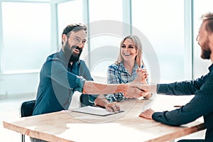 Smiling young man answering employers ` questions during the interview