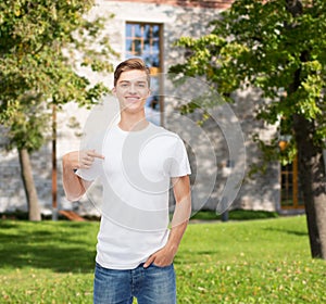 Smiling young man in blank white t-shirt