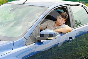 Smiling young man in the car