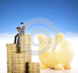 Smiling young man counting coin in piggy bank