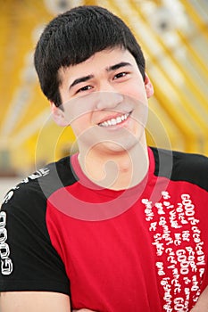 Smiling young man on footbridge
